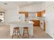 Bright kitchen with an island, white appliances, and tiled floors at 13208 W Desert Rock Dr, Surprise, AZ 85374