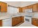 Bright kitchen offers white appliances and wood cabinets at 13208 W Desert Rock Dr, Surprise, AZ 85374