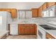 Well-lit kitchen features white appliances and wood cabinets at 13208 W Desert Rock Dr, Surprise, AZ 85374