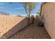 Narrow side yard with gravel, block wall, and an HVAC unit against a stucco-sided home at 13208 W Desert Rock Dr, Surprise, AZ 85374