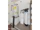 Utility room featuring water heater, water softener, and metal storage rack at 13208 W Desert Rock Dr, Surprise, AZ 85374