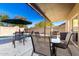 A backyard covered patio with outdoor furniture provides shade and comfort for enjoying time outdoors, near the pool at 13232 W Ironwood St, Surprise, AZ 85374