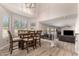 Bright dining room with a wood table and seating, adjacent to an open living space at 13232 W Ironwood St, Surprise, AZ 85374