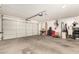 Spacious garage with ample room for parking and storage with a working garage door at 13232 W Ironwood St, Surprise, AZ 85374