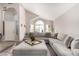 Inviting living room featuring vaulted ceiling, lots of natural light, and a comfortable sectional sofa at 13232 W Ironwood St, Surprise, AZ 85374