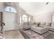 Bright living room featuring a vaulted ceiling, large windows, and a comfortable sectional sofa at 13232 W Ironwood St, Surprise, AZ 85374