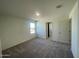 Bedroom with neutral carpet and a window, offering a bright and comfortable space at 13249 E Verbina Ln, Florence, AZ 85132