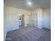 Neutral bedroom featuring grey carpet, white walls, and easy access to ensuite bathroom at 13249 E Verbina Ln, Florence, AZ 85132