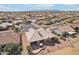 Aerial view of house with an outdoor patio in a desert neighborhood at 14110 W Robertson Dr, Sun City West, AZ 85375