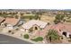 Aerial view of a beautiful home near the golf course with mature landscaping, including a putting green at 14110 W Robertson Dr, Sun City West, AZ 85375