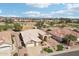 Aerial view of a beautiful home near the golf course with mature landscaping, including a putting green at 14110 W Robertson Dr, Sun City West, AZ 85375