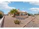 Lush desert landscaping surrounds the home with large windows providing natural light throughout at 14110 W Robertson Dr, Sun City West, AZ 85375