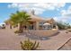 Lush desert landscaping surrounds the home with large windows providing natural light throughout at 14110 W Robertson Dr, Sun City West, AZ 85375