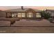 Backyard view featuring an outdoor dining area and desert landscaping at 14110 W Robertson Dr, Sun City West, AZ 85375