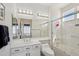 Bright bathroom featuring a shower over tub, large mirror, and a vanity with white cabinets at 14110 W Robertson Dr, Sun City West, AZ 85375