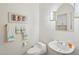 Clean powder room featuring a pedestal sink, decorative mirror, and coordinated towels at 14110 W Robertson Dr, Sun City West, AZ 85375