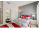 Comfortable bedroom featuring a queen bed, grey accent wall, plush carpeting, and ample closet space at 14110 W Robertson Dr, Sun City West, AZ 85375