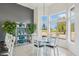 Bright dining area with seating for six and a view of the green golf course from the bay windows at 14110 W Robertson Dr, Sun City West, AZ 85375