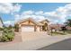 Single-story home featuring a spacious two-car garage, desert landscaping, mature cacti, and tiled roof at 14110 W Robertson Dr, Sun City West, AZ 85375