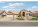 Beautiful home featuring desert landscaping, a tile roof, an arched entrance, and an attached two-car garage at 14110 W Robertson Dr, Sun City West, AZ 85375