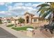 Charming desert home featuring manicured landscaping, a tile roof, and an attached two-car garage at 14110 W Robertson Dr, Sun City West, AZ 85375