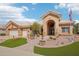 Charming single-story home with a well-manicured desert landscape, beautiful walkway, and a welcoming arched entryway at 14110 W Robertson Dr, Sun City West, AZ 85375