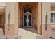 Close up of home's decorative double door entrance featuring a decorative security screen, and an arched entryway at 14110 W Robertson Dr, Sun City West, AZ 85375