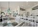 Bright kitchen with white cabinetry, granite counters, seating at the breakfast bar, and open access to a patio at 14110 W Robertson Dr, Sun City West, AZ 85375