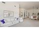 Bright, neutral living room featuring ample seating and an adjacent dining area with seating for six at 14110 W Robertson Dr, Sun City West, AZ 85375