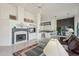 Bright living room featuring high ceilings, a fireplace, and an open floorplan to the kitchen and dining area at 14110 W Robertson Dr, Sun City West, AZ 85375