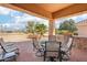 Covered patio with stone flooring, outdoor seating, a grill, and a stunning golf course view at 14110 W Robertson Dr, Sun City West, AZ 85375