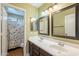 Well-lit bathroom with double sinks, updated fixtures, and neutral decor with a peek into the toilet room at 1446 E Oxford Ln, Gilbert, AZ 85295