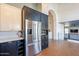 Stainless steel refrigerator and modern cabinetry in this spacious kitchen at 1446 E Oxford Ln, Gilbert, AZ 85295