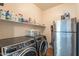 Utility room equipped with a washer, dryer, shelving and a refrigerator at 1446 E Oxford Ln, Gilbert, AZ 85295