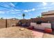 Well-fenced backyard with a built-in brick barbeque for outdoor cooking at 14957 W Bottle Tree Ave, Surprise, AZ 85374