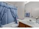 Bathroom featuring a vanity, toilet and combination shower and tub with light blue curtain at 14957 W Bottle Tree Ave, Surprise, AZ 85374