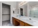 Bathroom with double sinks, a spacious mirror, and a combined shower-tub with decorative curtains at 14957 W Bottle Tree Ave, Surprise, AZ 85374