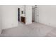 Bedroom featuring neutral carpet and access to a bathroom with a wooden vanity at 14957 W Bottle Tree Ave, Surprise, AZ 85374