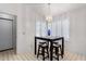 Charming dining area with a modern light fixture and a quaint breakfast table with stools at 14957 W Bottle Tree Ave, Surprise, AZ 85374