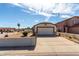 Charming single-story home featuring a well-maintained front yard and a two-car garage at 14957 W Bottle Tree Ave, Surprise, AZ 85374