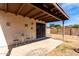 Covered patio featuring neutral decor and ample space to relax in the backyard at 14957 W Bottle Tree Ave, Surprise, AZ 85374