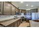 Well-lit kitchen with modern appliances, dark cabinetry, and ample counter space at 15137 W Yucatan Dr, Surprise, AZ 85379