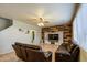 Comfortable living room featuring a wood accent wall and plush leather seating at 15137 W Yucatan Dr, Surprise, AZ 85379