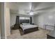 Spacious main bedroom featuring neutral tones, ceiling fan, and carpet flooring at 15137 W Yucatan Dr, Surprise, AZ 85379