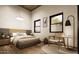 Cozy bedroom featuring a comfy bed, wood flooring, and bright light from the windows at 15674 S Overfield Rd, Arizona City, AZ 85123