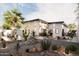 Modern house exterior featuring desert landscaping with palm trees and stone accents in the yard at 15674 S Overfield Rd, Arizona City, AZ 85123