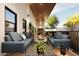 Inviting outdoor living area with sofas, wood floors and a relaxing view of the backyard at 15674 S Overfield Rd, Arizona City, AZ 85123