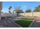 Spacious backyard featuring a dining set, lounge chairs, artificial grass, and desert landscaping at 16546 E Ashbrook Dr # A, Fountain Hills, AZ 85268