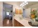 Well-lit bathroom with a full mirror over the vanity and a view of the bright bedroom at 16546 E Ashbrook Dr # A, Fountain Hills, AZ 85268