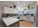 Well-lit kitchen with white cabinetry, granite countertops, and stainless steel appliances at 16546 E Ashbrook Dr # A, Fountain Hills, AZ 85268